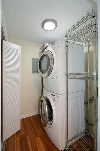 a view of a patio with table and chairs potted plants and large tree