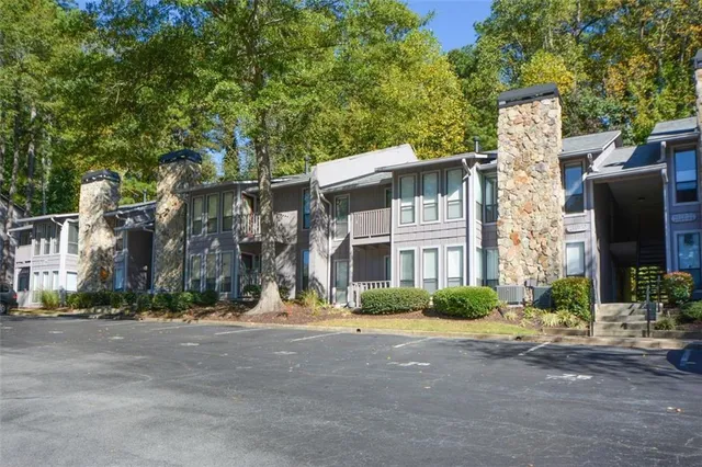 a view of a room with wooden floor and a ceiling fan