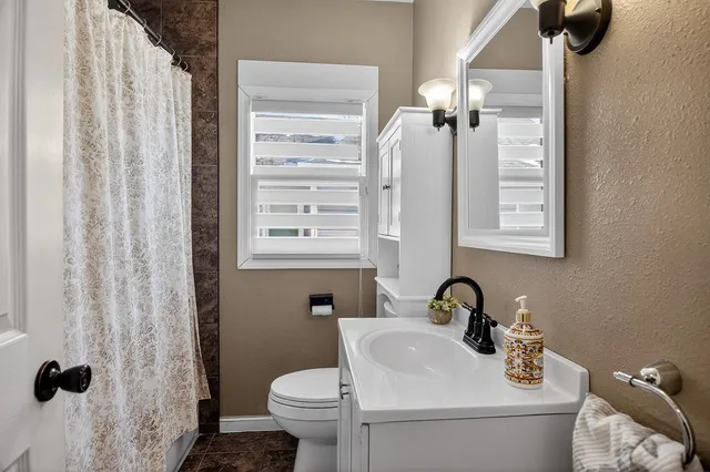 a bathroom with a sink toilet and shower