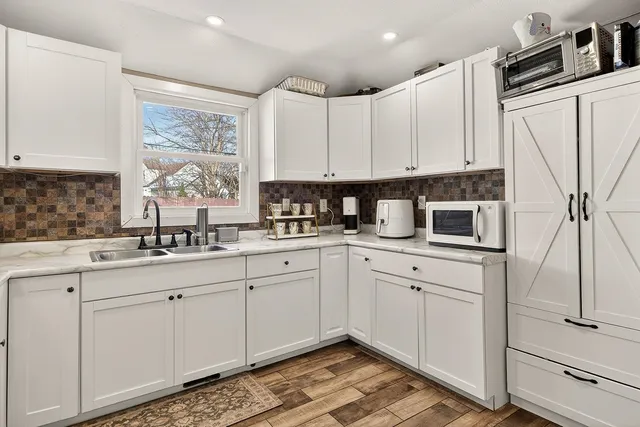 a kitchen with appliances cabinets and a sink