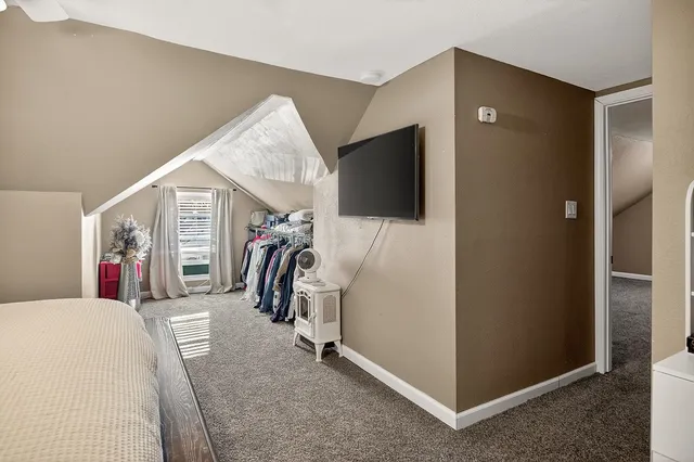 a view of a livingroom with furniture and a flat screen tv