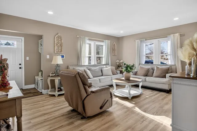 a living room with furniture and wooden floor