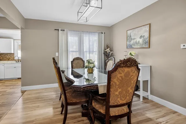 a view of a dining room with furniture and wooden floor