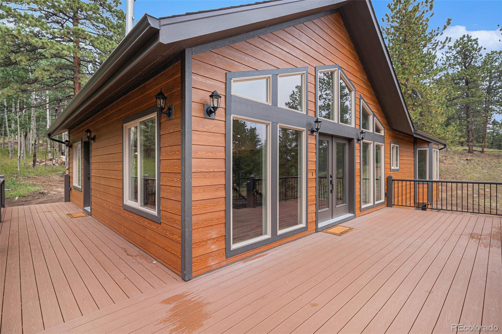 68 Aspen Drive Bailey, CO 80421 - Photo 27 of 35 a view of backyard with large trees and wooden floor