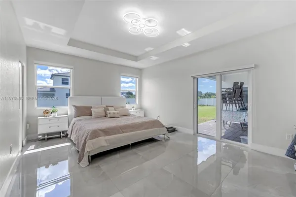 a bedroom with a bed and a lamp