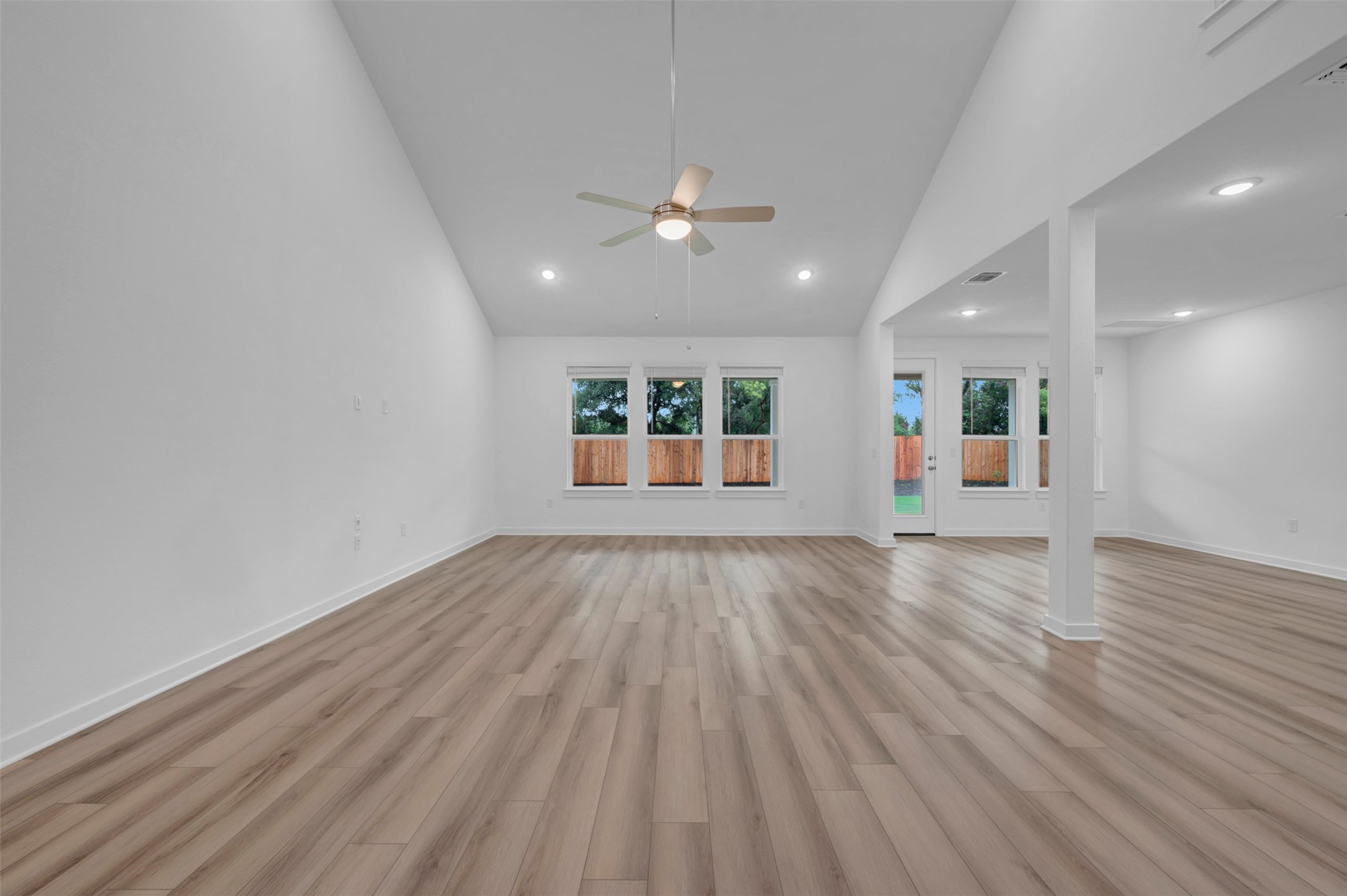 3705 Helena Way Leander, TX 78641 - Photo 16 of 40 an empty room with wooden floor ceiling fan and windows