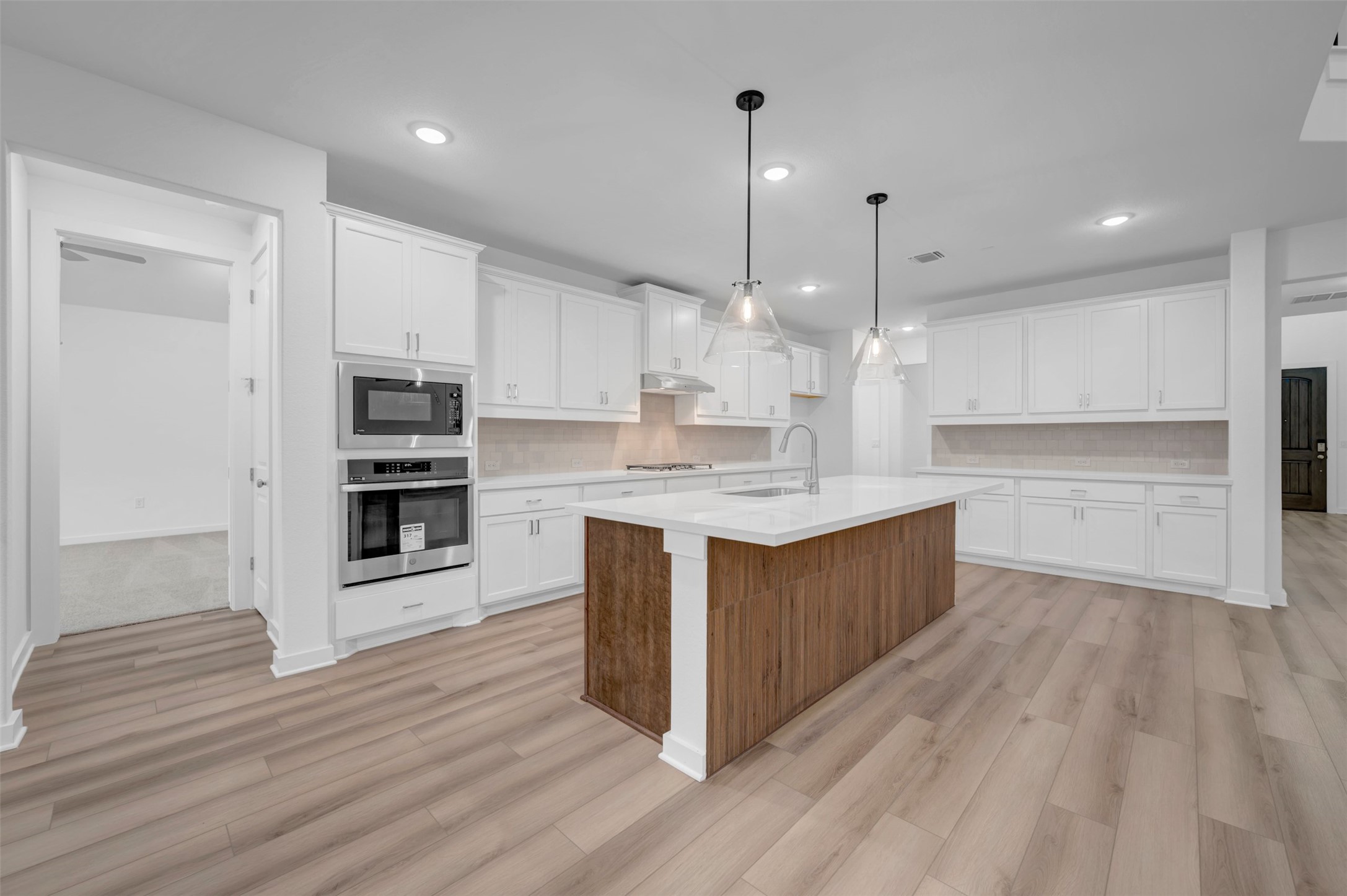 3705 Helena Way Leander, TX 78641 - Photo 17 of 40 a large kitchen with kitchen island a sink stainless steel appliances and cabinets