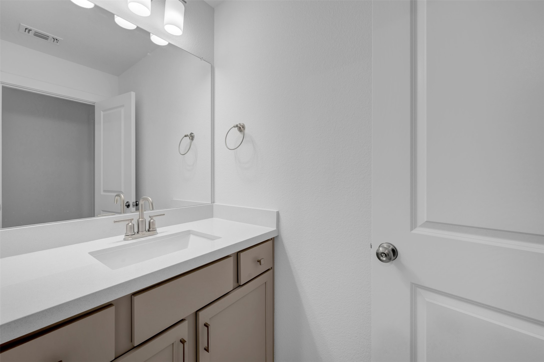 3705 Helena Way Leander, TX 78641 - Photo 30 of 40 a bathroom with a sink vanity and a mirror