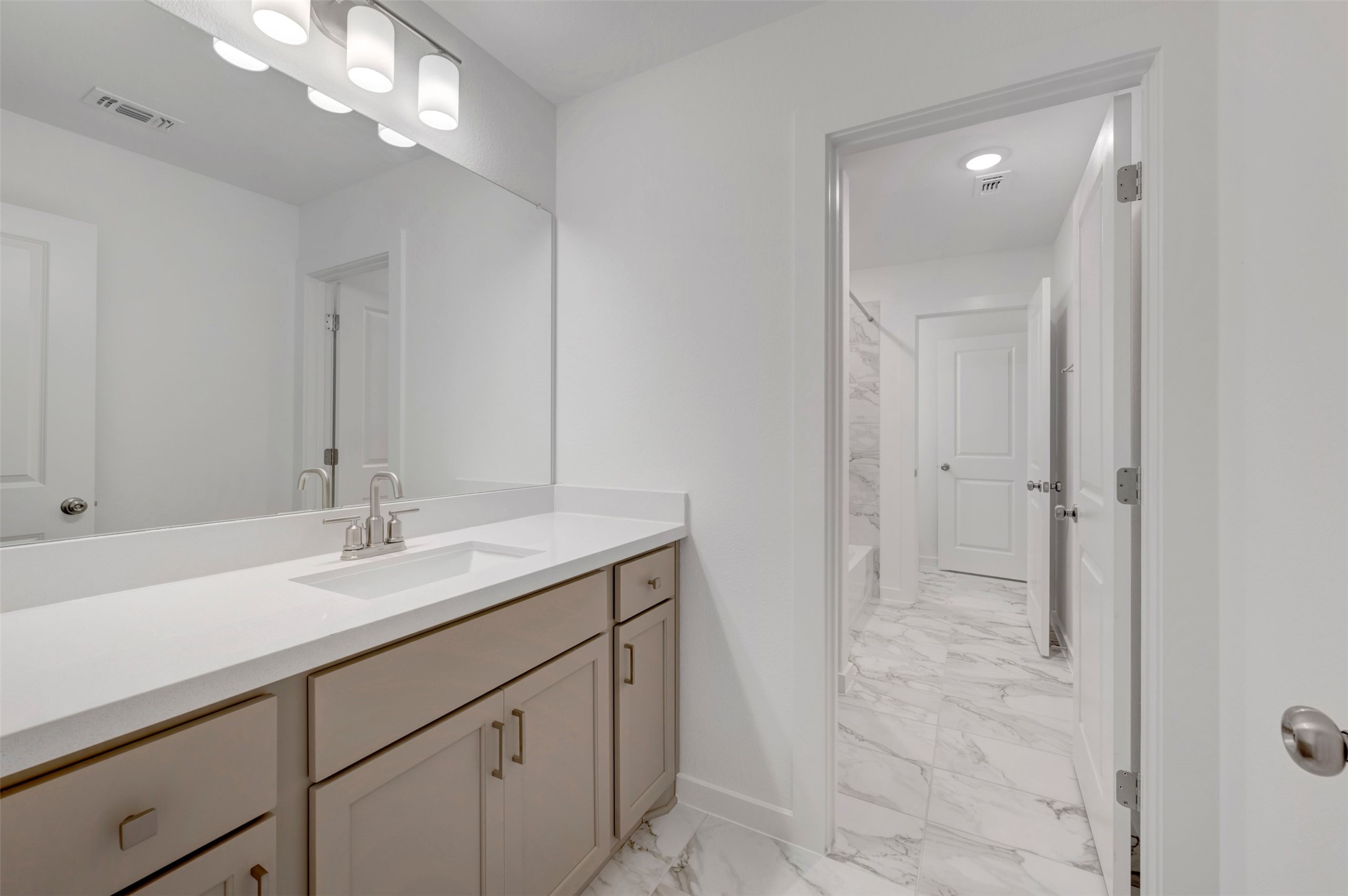 3705 Helena Way Leander, TX 78641 - Photo 32 of 40 a bathroom with a sink a vanity and a mirror