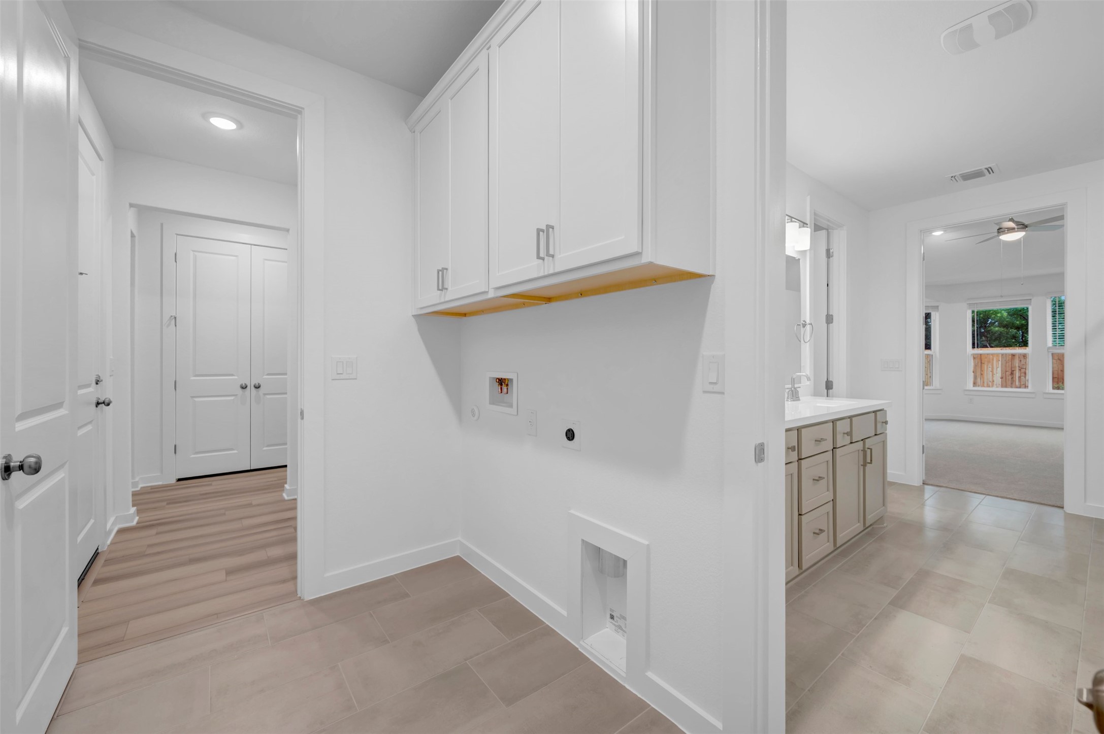 3705 Helena Way Leander, TX 78641 - Photo 10 of 40 a kitchen with white cabinets and white appliances
