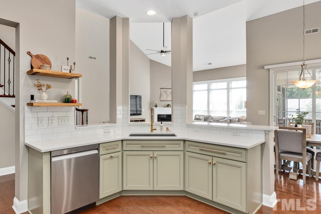 1136 Chapanoke Road Raleigh, NC 27603 - Photo 15 of 48 a kitchen with white cabinets and sink