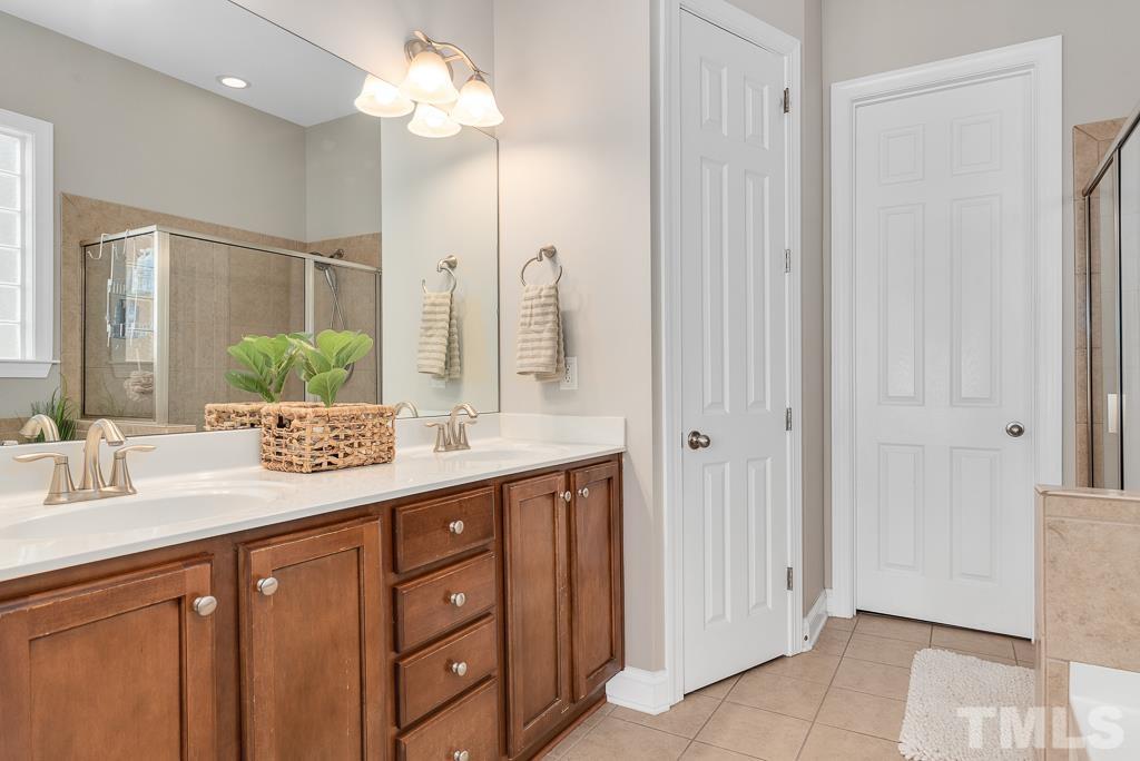 1136 Chapanoke Road Raleigh, NC 27603 - Photo 23 of 48 a bathroom with a granite countertop sink and a mirror