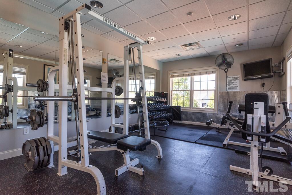 1136 Chapanoke Road Raleigh, NC 27603 - Photo 47 of 48 a living room with lots of furniture and gym equipment
