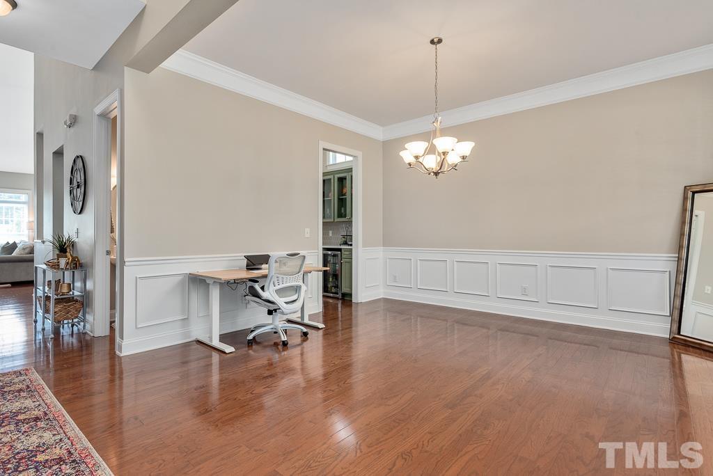 1136 Chapanoke Road Raleigh, NC 27603 - Photo 7 of 48 a view of a livingroom with hardwood floor and a ceiling fan