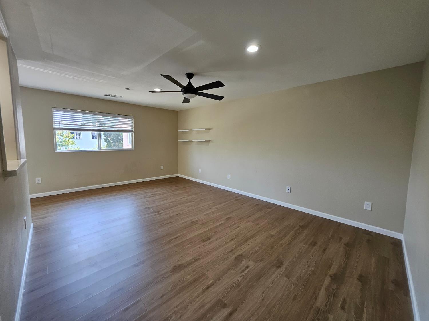25231 Whitman Street, Unit 103 Hayward, CA 94544 - Photo 14 of 30 an empty room with wooden floor and windows