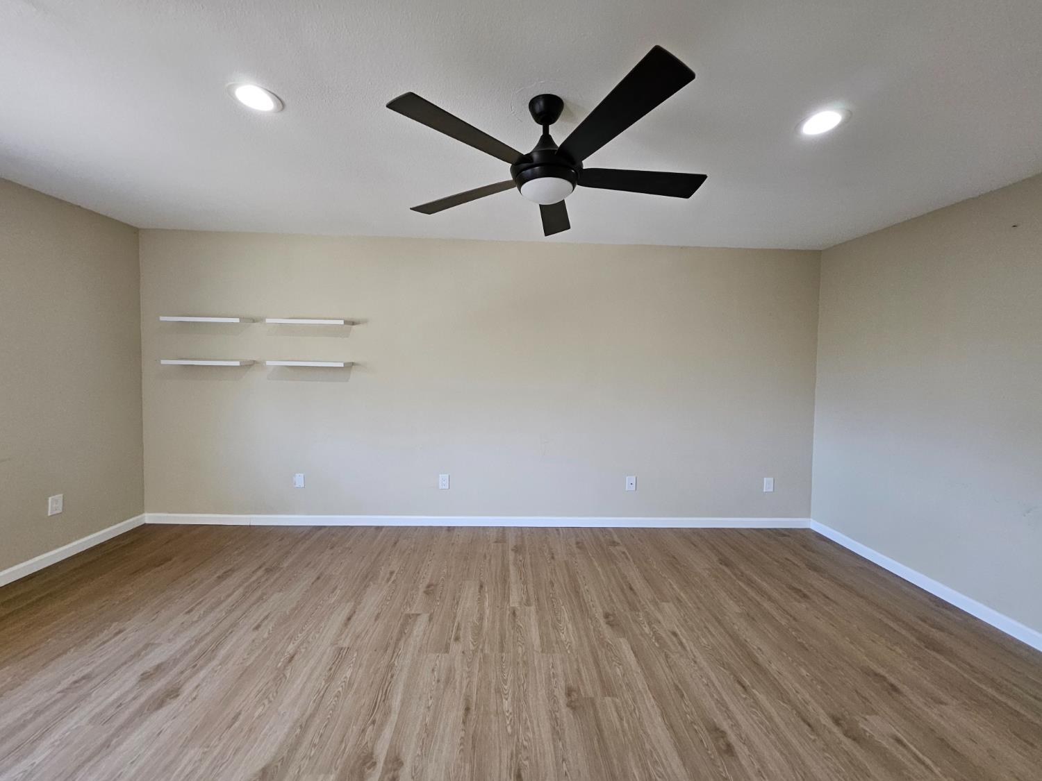 25231 Whitman Street, Unit 103 Hayward, CA 94544 - Photo 16 of 30 an empty room with wooden floor and windows