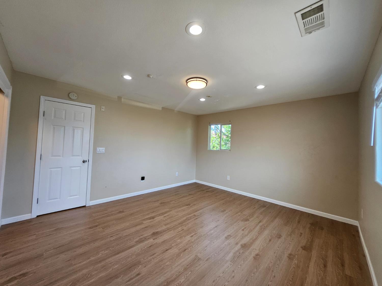 25231 Whitman Street, Unit 103 Hayward, CA 94544 - Photo 20 of 30 an empty room with window and wooden floor