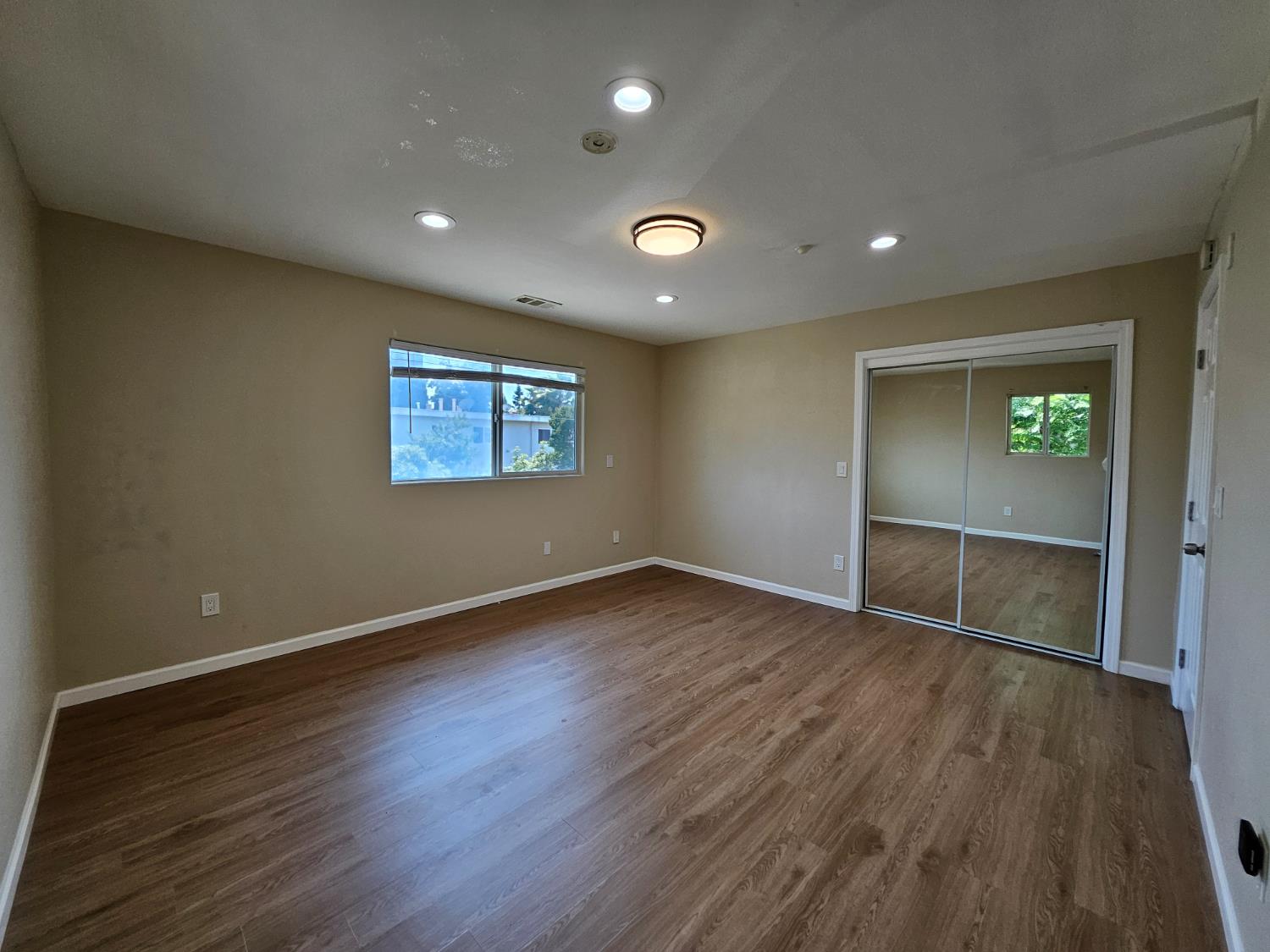 25231 Whitman Street, Unit 103 Hayward, CA 94544 - Photo 21 of 30 an empty room with wooden floor and window