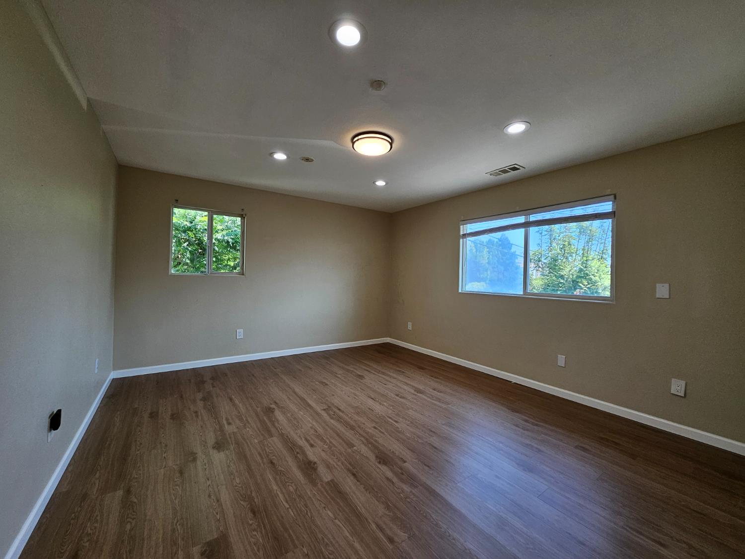 25231 Whitman Street, Unit 103 Hayward, CA 94544 - Photo 22 of 30 an empty room with wooden floor and windows