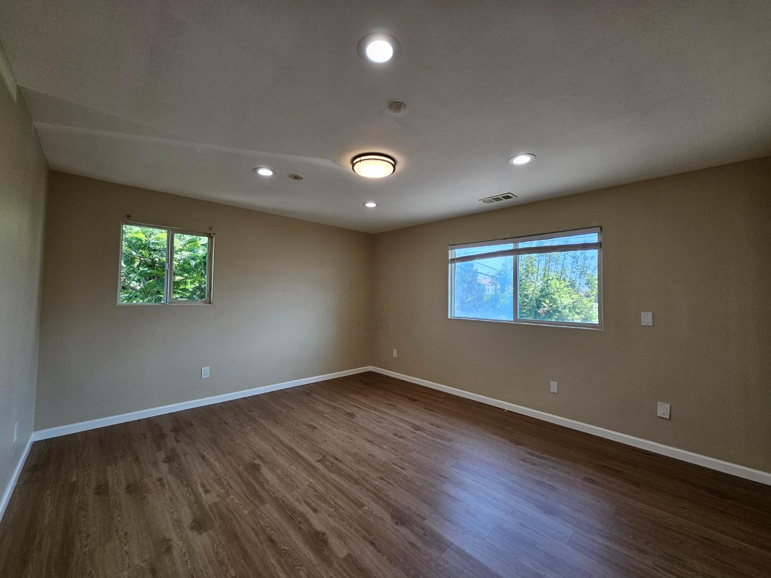 25231 Whitman Street, Unit 103 Hayward, CA 94544 - Photo 23 of 30 a view of an empty room with wooden floor and a window