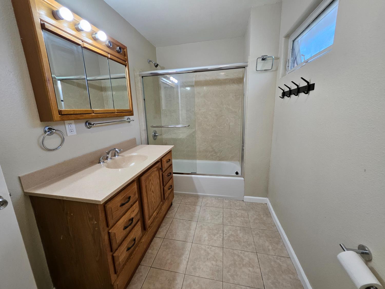 25231 Whitman Street, Unit 103 Hayward, CA 94544 - Photo 25 of 30 a bathroom with a sink a mirror and a shower