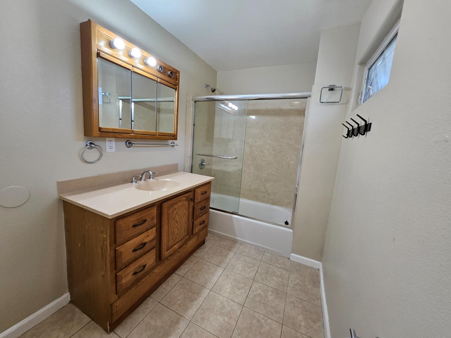 25231 Whitman Street, Unit 103 Hayward, CA 94544 - Photo 26 of 30 a bathroom with a sink mirror vanity and a bathtub