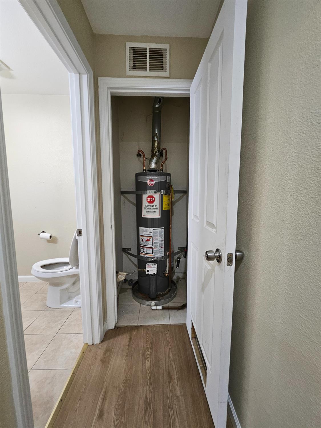 25231 Whitman Street, Unit 103 Hayward, CA 94544 - Photo 30 of 30 a view of a hallway with wooden floor and a bathroom