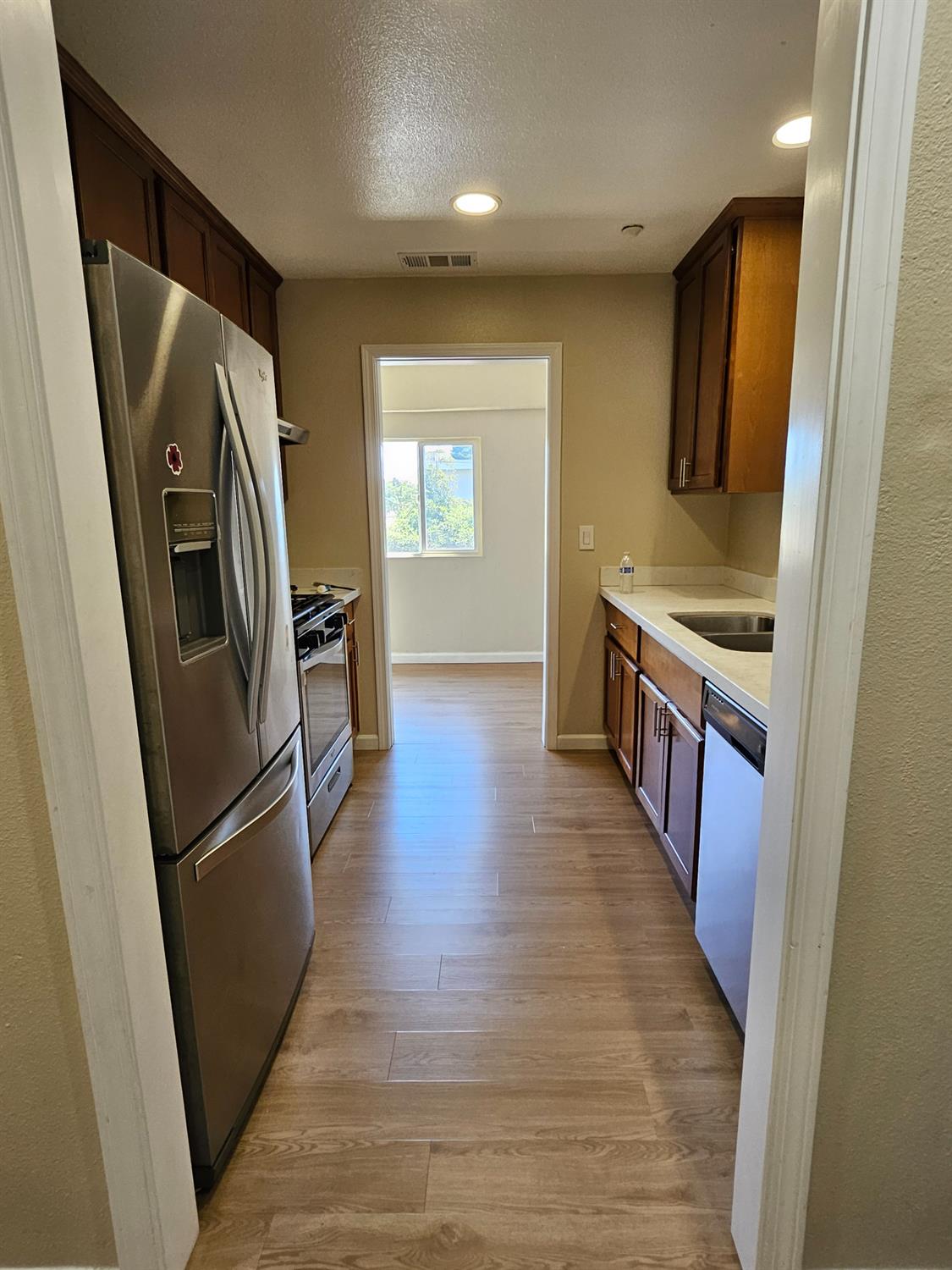 25231 Whitman Street, Unit 103 Hayward, CA 94544 - Photo 7 of 30 an empty room with wooden floor and entrance