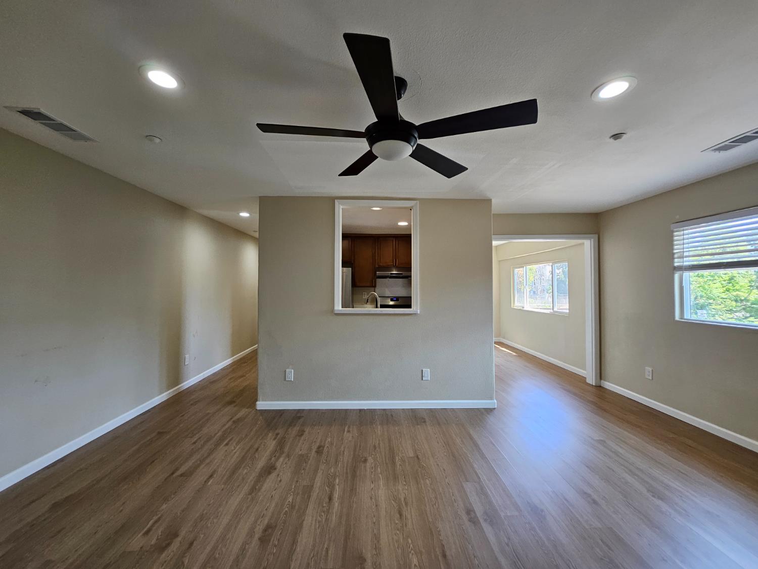 25231 Whitman Street, Unit 103 Hayward, CA 94544 - Photo 10 of 30 an empty room with wooden floor and windows