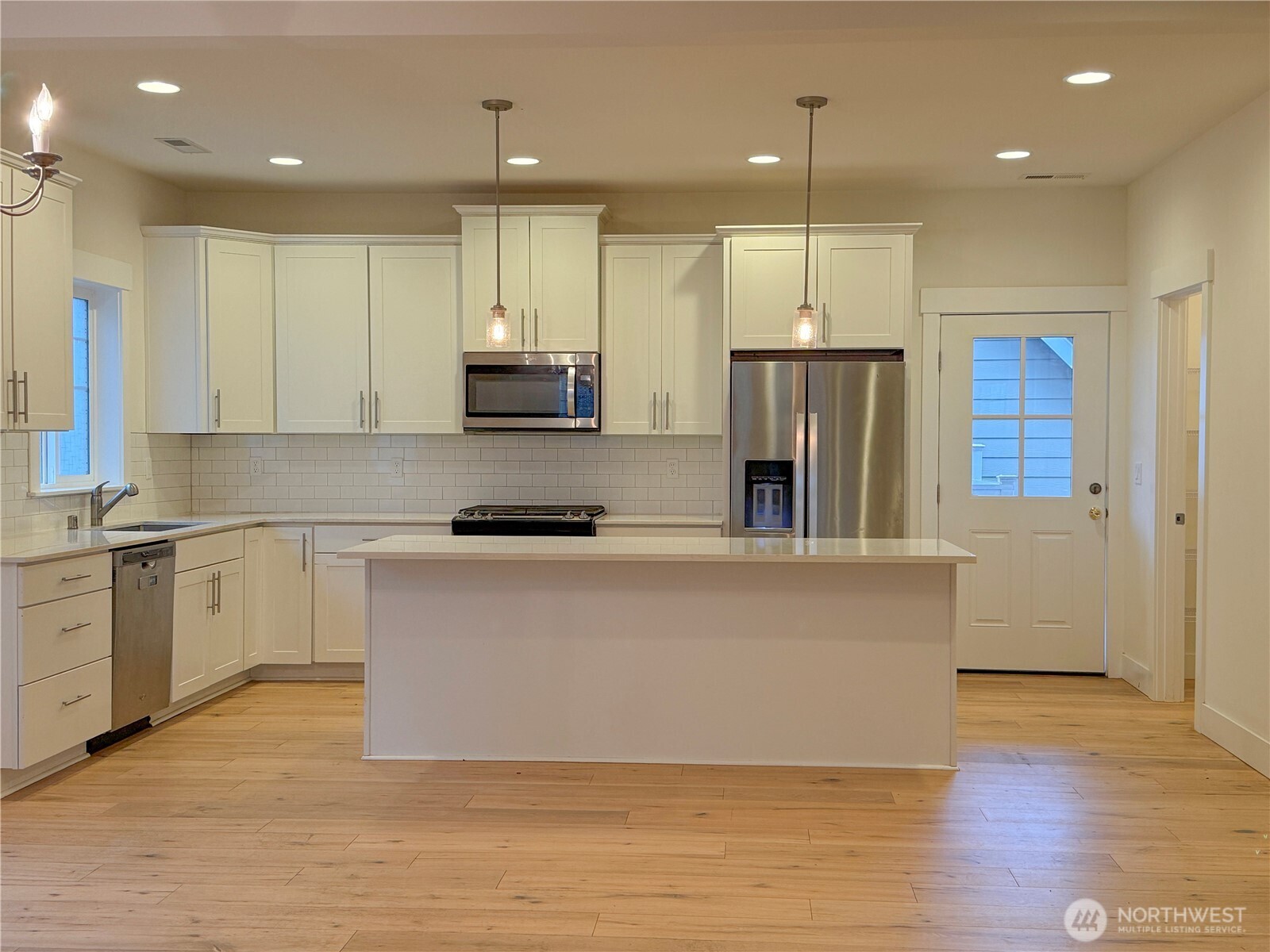30 East Compass Lane, Unit A98524 Allyn, WA 98524 - Photo 28 of 36 a large kitchen with stainless steel appliances granite countertop a large center island a stove a refrigerator a sink and a cabinets