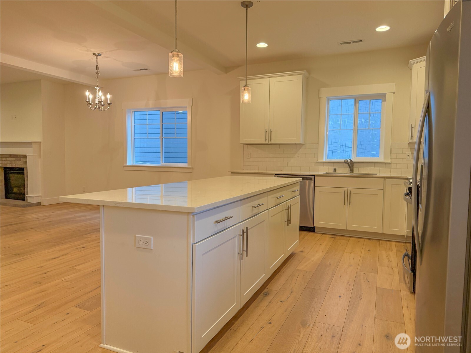 30 East Compass Lane, Unit A98524 Allyn, WA 98524 - Photo 4 of 36 a kitchen with stainless steel appliances granite countertop a sink a stove a refrigerator and island with wooden floor