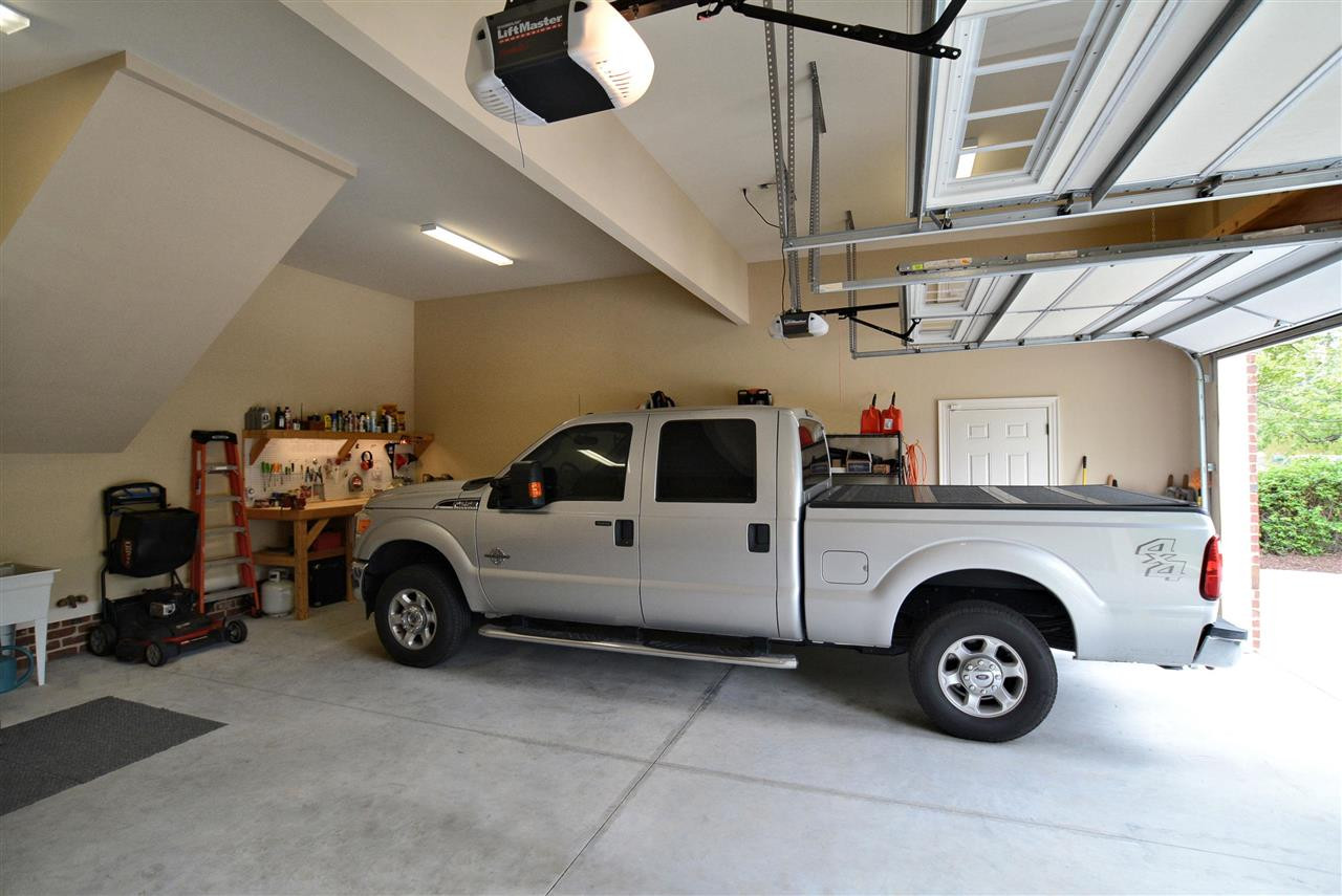 1322 Dogwood Lane Raleigh, NC 27607 - Photo 23 of 30 The Garage has extra depth for parking longer vehicle w/room for using the Custom Work Bench. Garage also features a Utility Sink, Hot/Cold Water Hose Spigot, Pedestrian Door, Built-in Storage above Garage Drs & Belt-driven Garage Dr Openers. Oversized 2 Car Garage