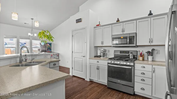 a kitchen view with stainless steel appliances a refrigerator and a stove