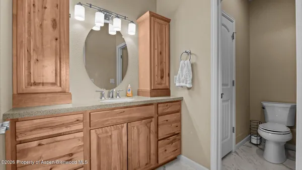 a bathroom with a granite countertop shower sink and mirror