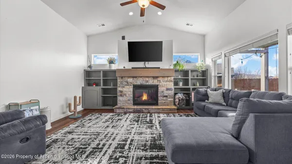 a living room with furniture and a view of kitchen