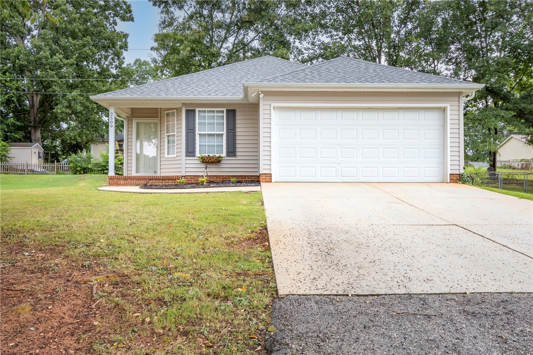 2509 Rolling Green Road Anderson, SC 29621 - Photo 1 of 28 A welcoming facade with a garage and well-maintained front yard offers convenient living.