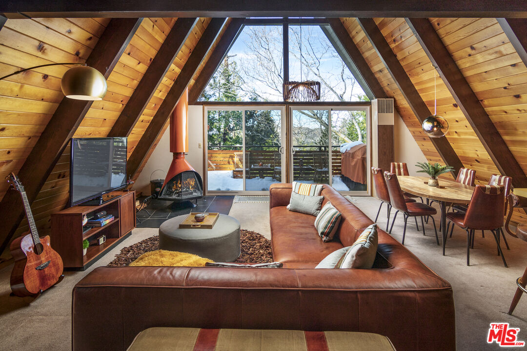 a living room with furniture and a floor to ceiling window
