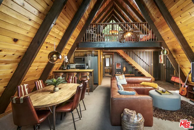a dining room with furniture and a chandelier