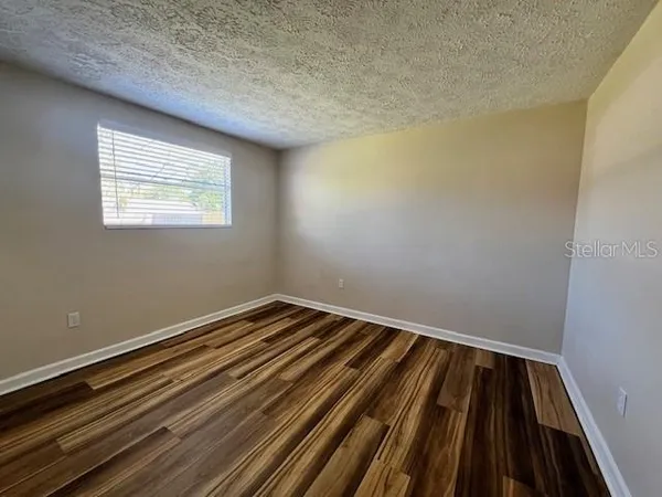 a view of a room with wooden floor and staircase