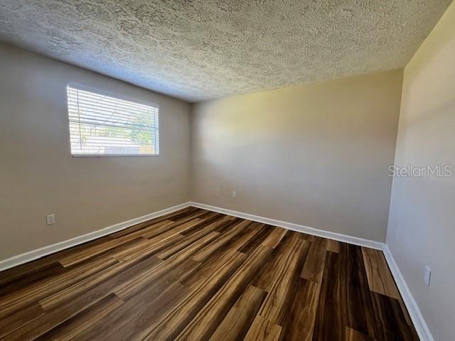 6413 Sutters Mill Road New Port Richey, FL 34653 - Photo 14 of 20 a view of a room with wooden floor and staircase