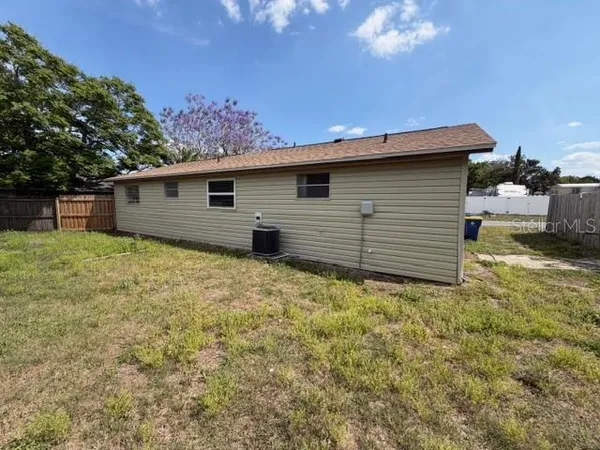 a backyard of a house with yard and garage