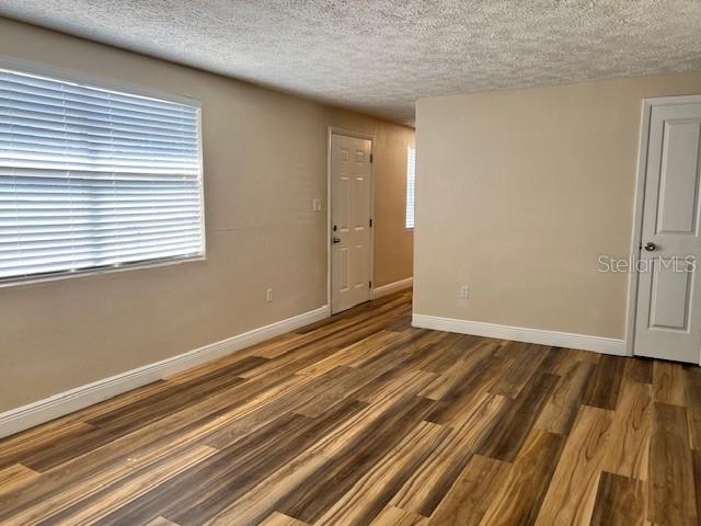 6413 Sutters Mill Road New Port Richey, FL 34653 - Photo 4 of 20 a view of an empty room with wooden floor and a window