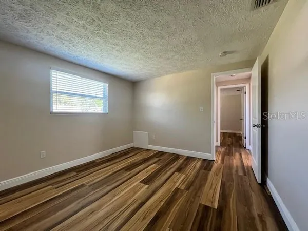 a view of a room with wooden floor