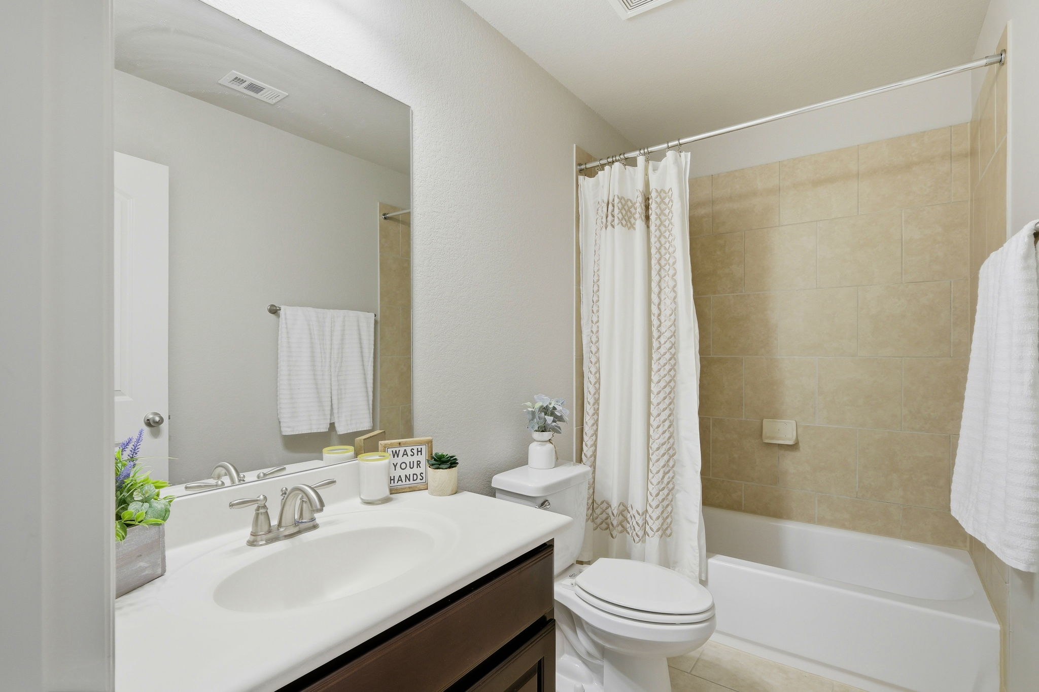 110 Dasher Drive Cedar Park, TX 78613 - Photo 24 of 39 A well-appointed bathroom with a spacious vanity and a bathtub features tiled walls.
