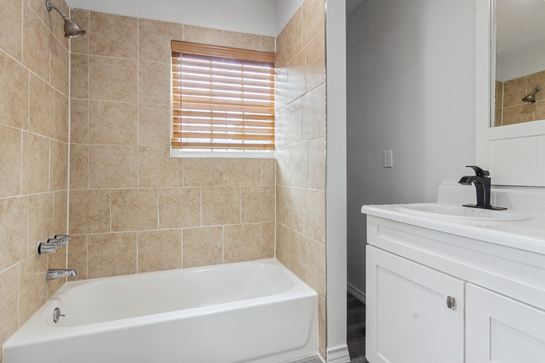 4505 Cochran Street Houston, TX 77009 - Photo 16 of 25 a white bath tub sitting next to a window