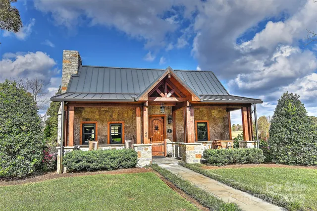 a view of a house with a yard and a slide