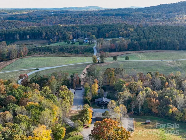 a view of a swimming pool with a yard and plants