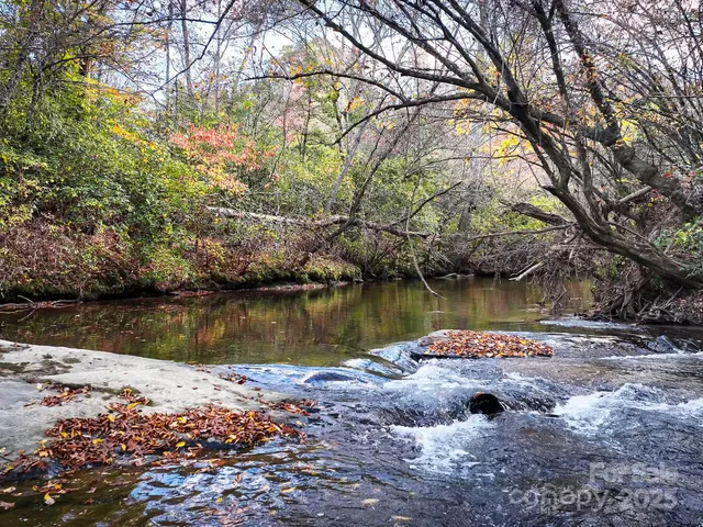 a view of white house with a yard