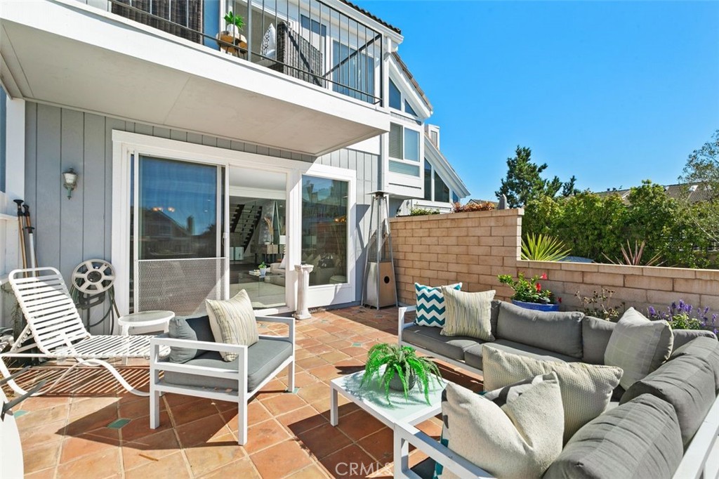 16117 St Croix Circle Huntington Beach, CA 92649 - Photo 14 of 45 front view of a patio with couches table and chairs with potted plants
