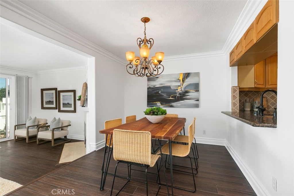 16117 St Croix Circle Huntington Beach, CA 92649 - Photo 17 of 45 a dining room with chandelier and wooden floor